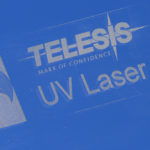 Glass marked to say "Telesis Mark of Confidence, UV Laser"