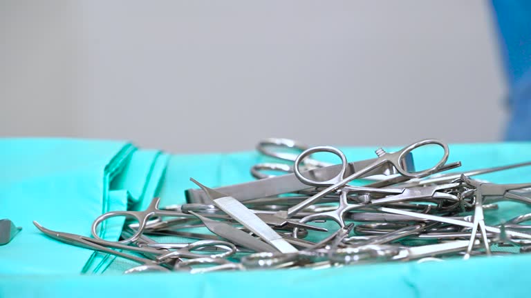 scrub nurse preparing surgical instruments for operation.