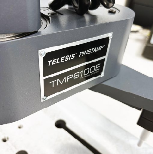 Close-up of the Telesis PINSTAMP TMP6100E Marking System nameplate